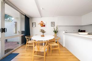 a kitchen and dining room with a table and chairs at Stylish apt facing the historic Telopea Park - Hosted by CanStay in Kingston 