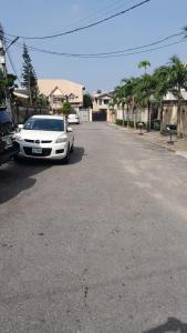a white car parked on the side of a street at Magodo Treat in Lagos
