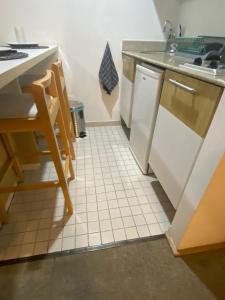 una cucina con lavandino e pavimenti piastrellati bianchi di Flat Alphaville - ComfortSuites a Barueri