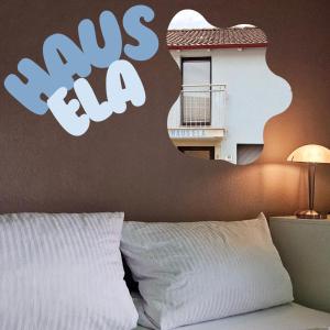 a bedroom with a bed with a sign on the wall at Haus Ela 