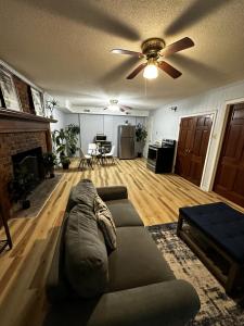 a living room with a couch and a ceiling fan at Private 1BR Mins to Downtown, Serene Backyard in Gastonia