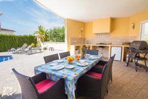 een eettafel met stoelen en een keuken bij Villa Esplendida by Abahana Villas in Calpe