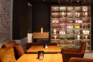 a restaurant with tables and chairs and a wall with shelves at Schwarzes Rössl in St. Wolfgang