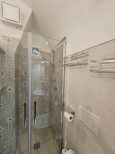a shower with a glass door in a bathroom at Caure Vista Mare in Polignano a Mare +28 photos
