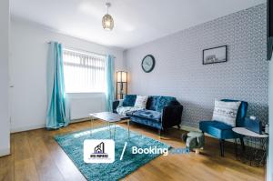 a living room with a couch and a table at 4 Bedroom House Free Parking By NYOS PROPERTIES Short Lets & Serviced Accommodation Manchester in Manchester