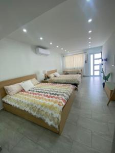 three beds are lined up in a room at Sea Breeze Tunnel Hideaway 7 in Quebradillas +18 photos