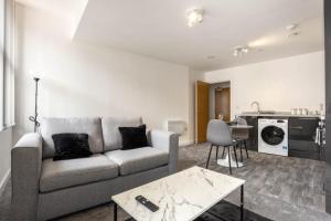 un soggiorno con divano e tavolo di Bright 1 Bedroom Apartment in Central Sheffield a Sheffield