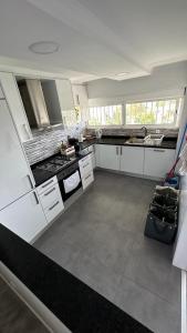 a kitchen with white cabinets and a counter top at Quarto Aeroporto in Lisbon