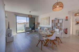 a living room with a table and chairs and a couch at OurMadeira - Vila Diana in Porto Santo
