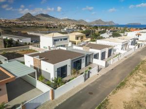 an aerial view of a row of white houses at OurMadeira - Vila Diana in Porto Santo