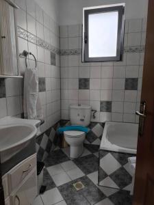 a bathroom with a toilet and a sink and a tub at Anna's Garden House in Limenas +10 photos