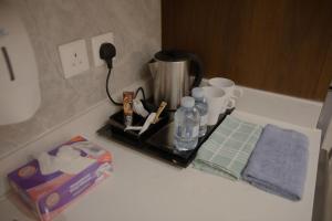 a counter top with a coffee maker on a counter top at فندق نارس بلس النزهة - Nars Plus Hotel in Jeddah