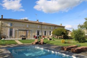 a house with a swimming pool in front of it at La Vigneraie de Laura in Sainte-Colombe
