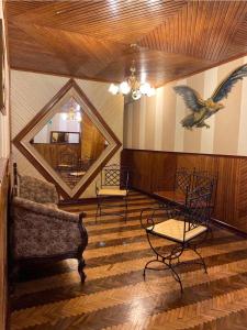 a living room with furniture and a bird on the wall at Hotel Metropolitano in Loja