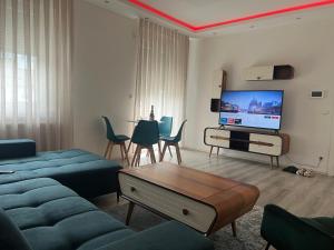 a living room with a couch and a tv at Apartment 1 in Duisburg-Mitte, Altstadt in Duisburg