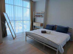 a bedroom with a bed and a large window at Family Holiday Fun APT Netflix by MESA in Nagoya +19 photos