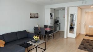 uma sala de estar com um sofá e uma mesa em Kotimaailma Apartments Vapaudenkatu 40-50 B8 em Jyväskylä