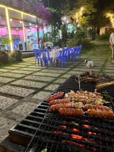 a grill with many different types of food on it at Tran Chau Garden Home in Cat Ba