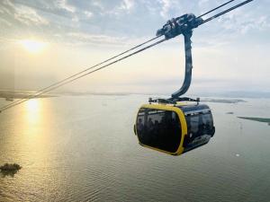 a cable car flying over a body of water at Tran Chau Garden Home in Cat Ba