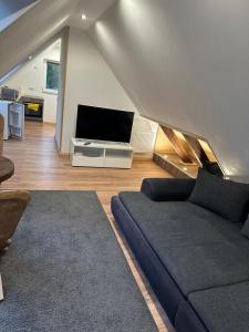a living room with a couch and a flat screen tv at Casa Pedro in Osnabrück
