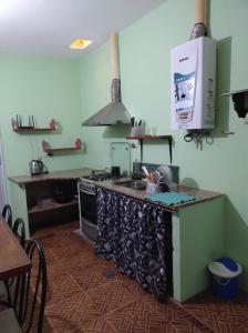 a kitchen with a sink and a stove top oven at yusulpayki in Termas de Río Hondo