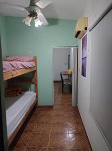 a room with two bunk beds and a ceiling fan at yusulpayki in Termas de Río Hondo