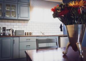 a vase of flowers on a table in a kitchen at SLEEP INN - Bethlehem in Bethlehem