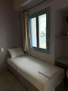 a bed in a room with a window at PARALIA Souli di mare in Parga