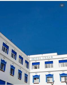 a white building with a hotel casino sign on it at Cèsar in Vilanova i la Geltrú