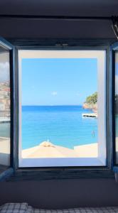 a window with a view of the beach at PARALIA Souli di mare in Parga