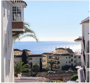 a view of the ocean from a building at SUPERBE T3 RIVIERA DEL SOL Plage et commerces 4mn in Mijas