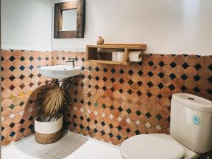 a bathroom with a toilet and a sink at Surfiscamp Dakhla in Dakhla