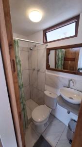 a small bathroom with a toilet and a sink at Villa Aventura Lodge in Cajamarca