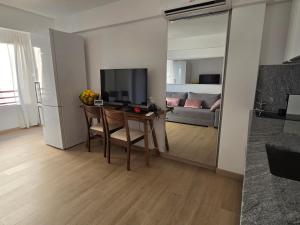 a living room with a table with a television and a couch at Apartamento Mar y Paz 15 in Calpe
