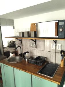 a kitchen counter top with a sink and a stove at B&L Chic apartment in Škaljari