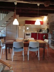 een keuken met een houten tafel en stoelen bij Gîte La Veyrie in Cazals