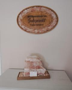 a sign on a wall above a rock on a shelf at Salzpunkt in Sankt Peter am Bichl