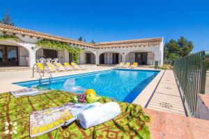 a villa with a swimming pool next to a house at Villa Fumepacoon by Abahana Villas in Benissa