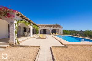 a villa with a swimming pool and a house at Villa Fumepacoon by Abahana Villas in Benissa