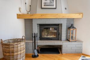 a living room with a white brick fireplace at Cerdacul din Livada - Căsuța din Livadă in Vaideeni
