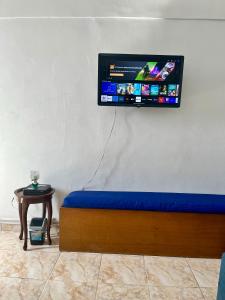 a flat screen tv hanging on a wall at Studio no Largo da Carioca - Rio de Janeiro in Rio de Janeiro