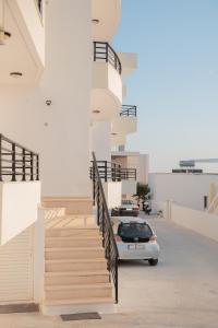 a stairway with a car parked in a parking lot at Central Rooms in Makry Gialos