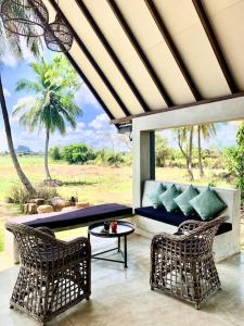 a living room with two chairs and a table at Linwewa Villa, Sigiriya in Sigiriya