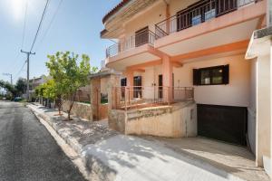 an empty street in front of a building at Perfect House in Spata in Spáta