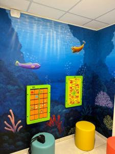 a wall mural of an aquarium in a room at Hotel Montreal in Bibione