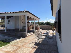 a patio with chairs and a gazebo at Quinta dos Sonhos in Aldeia dos Fernandes