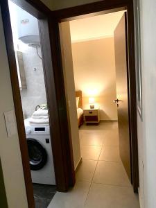 a hallway with a washing machine in a room at lividio apartment in Lefkada
