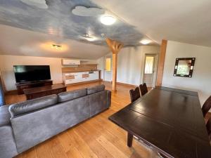 a living room with a couch and a table at Altstadthotel Ilsenburg in Ilsenburg