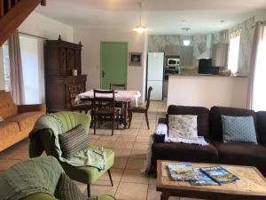 a living room with a couch and a table at Les Trégorines-Squibernévez in Pédernec