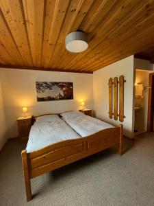 a bedroom with a bed with a wooden ceiling at Gästehaus Dürnberger in Molln